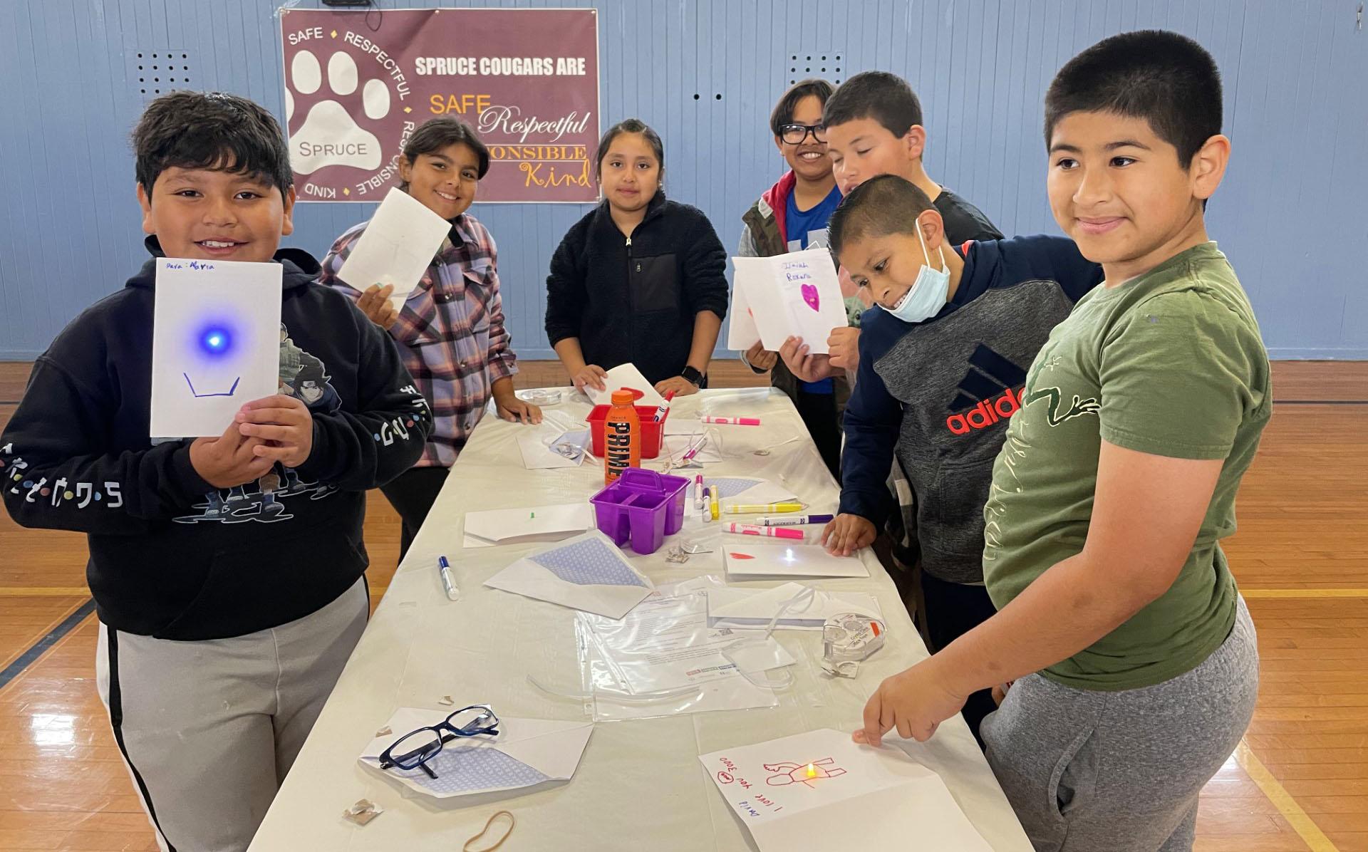 Spruce Elementary fifth graders make electrical circuits using paper during the school's science festival on May 12, 2023.